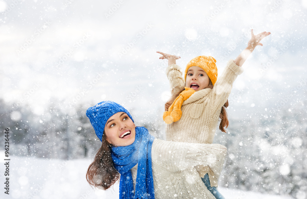 Mother and child girl on a winter walk