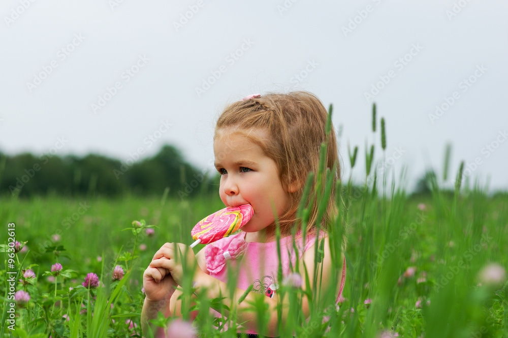  little girl eating a lollipop