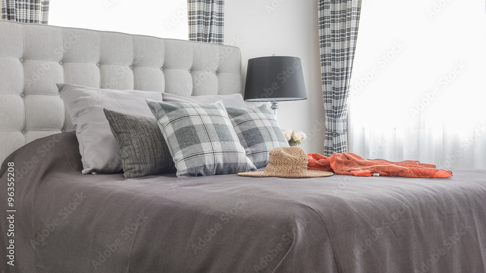 classic bed with pillows, hat, cloth and black lamp