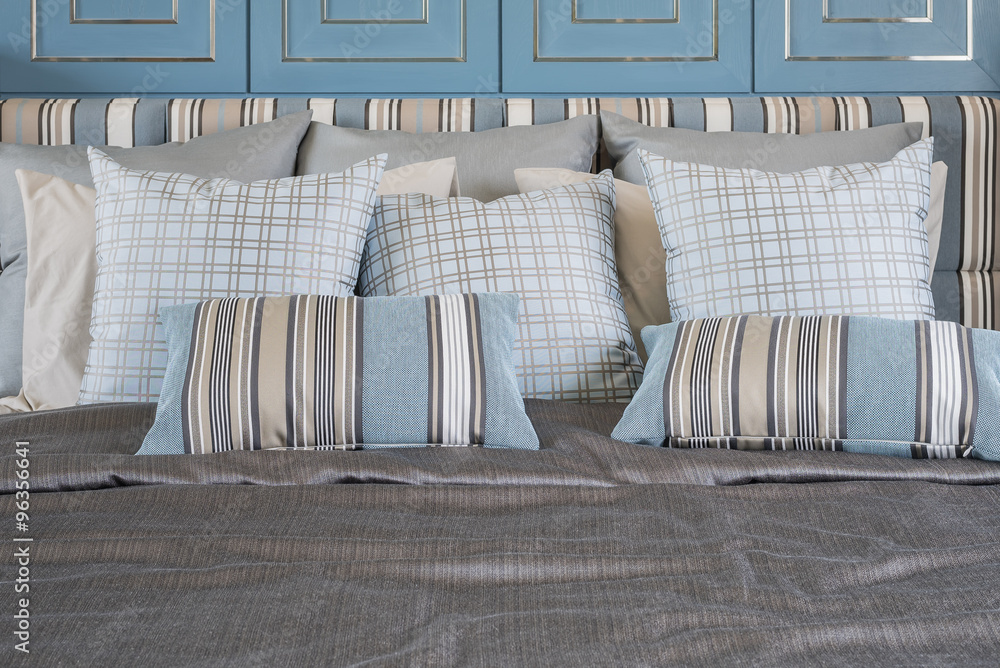 blue pillows on luxury bed in blue bedroom