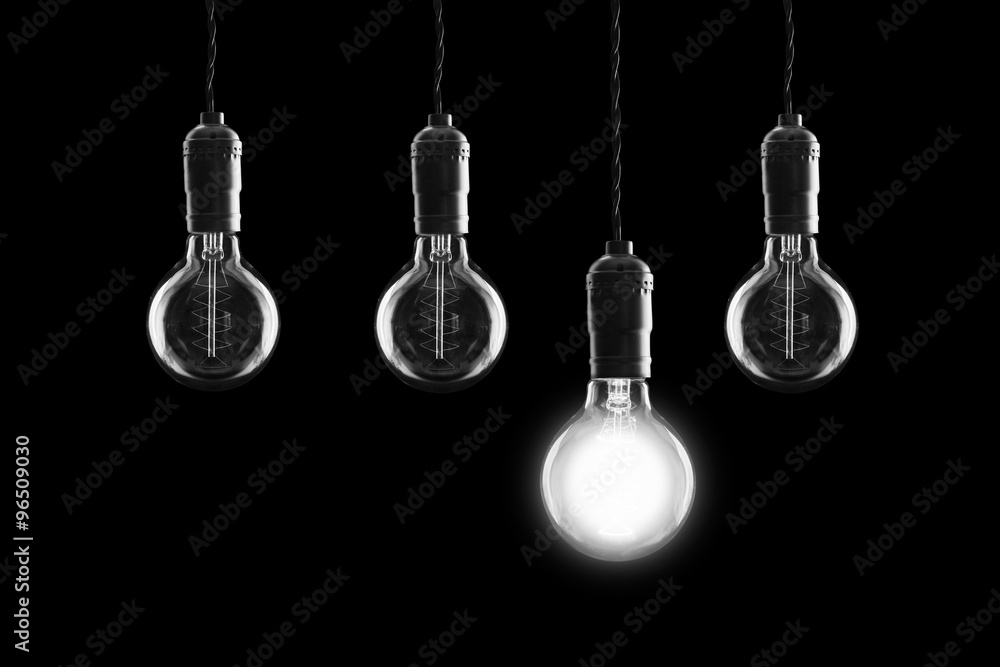 Idea and leadership concept Vintage incandescent Edison bulbs on