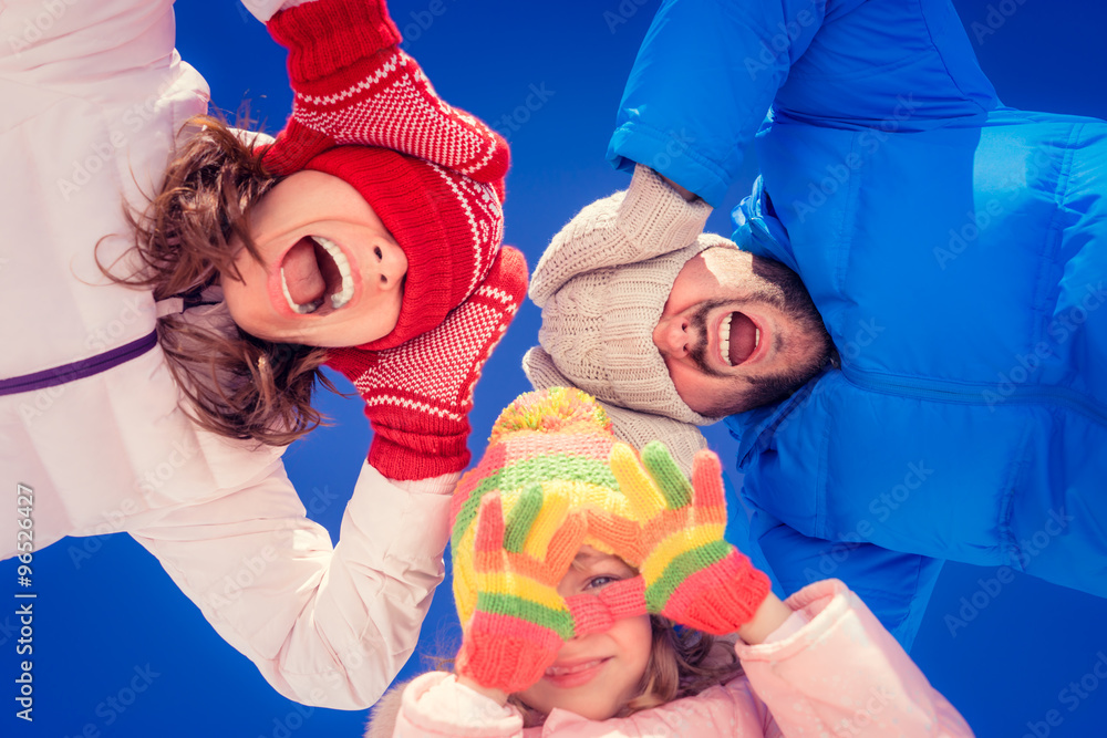 Children hands in red gloves against winter sky