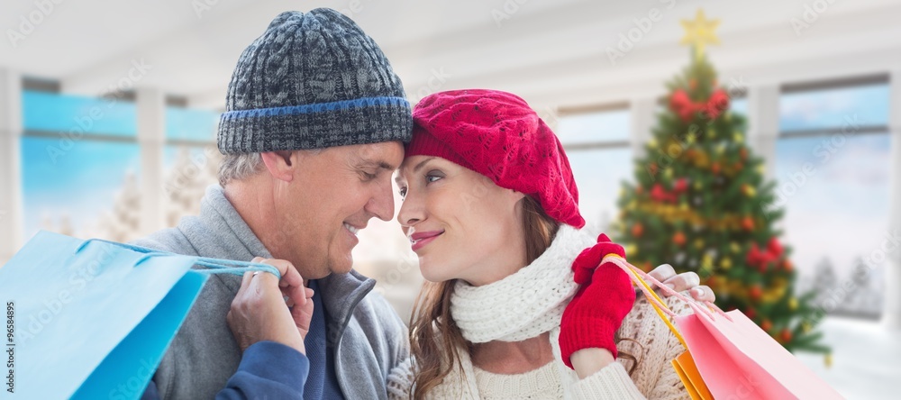 Composite image of couple with shopping bags