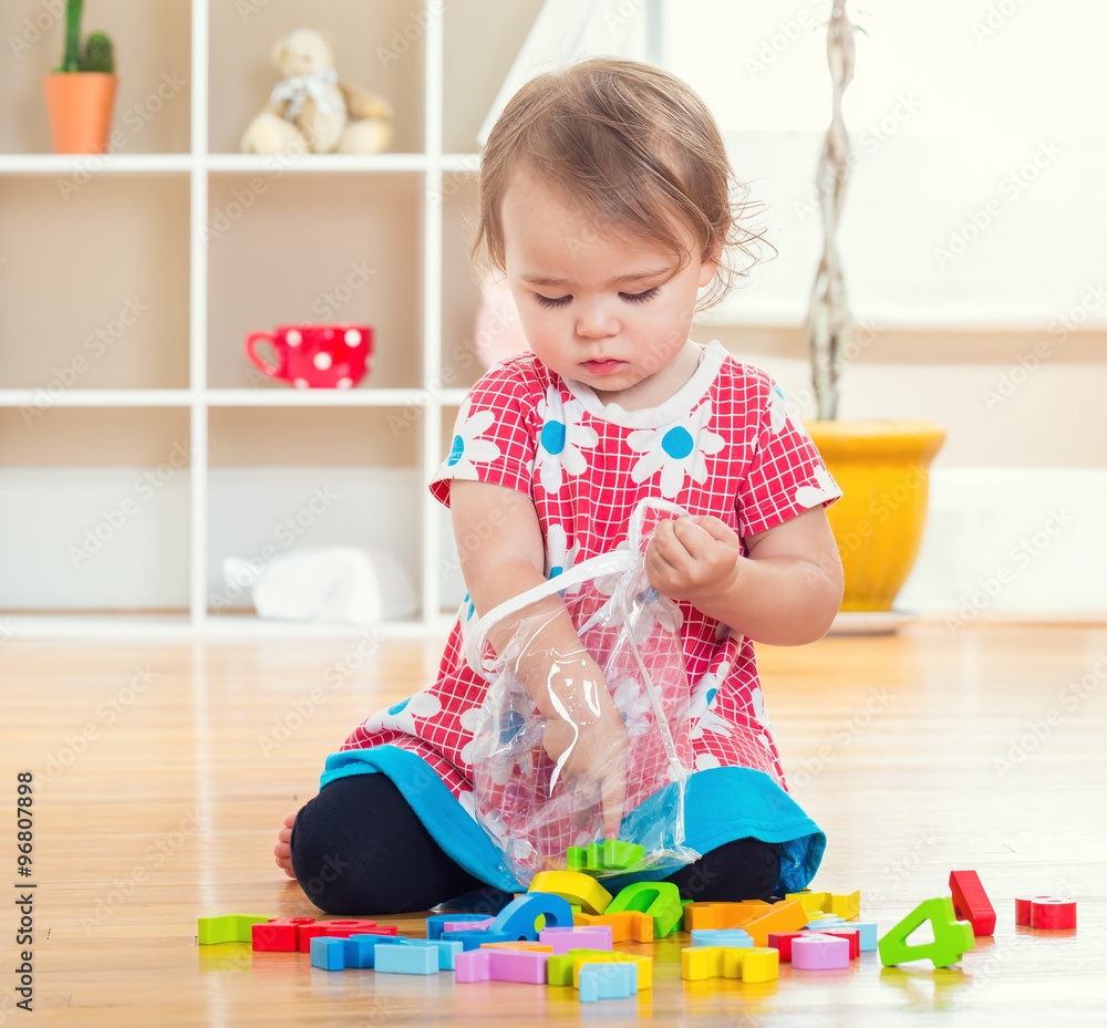 Toddler girl playing with her toys