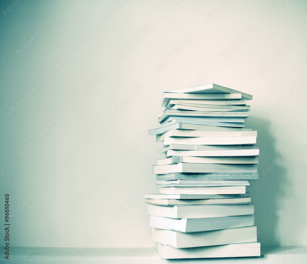 Close up book stacked with the concrete wall background