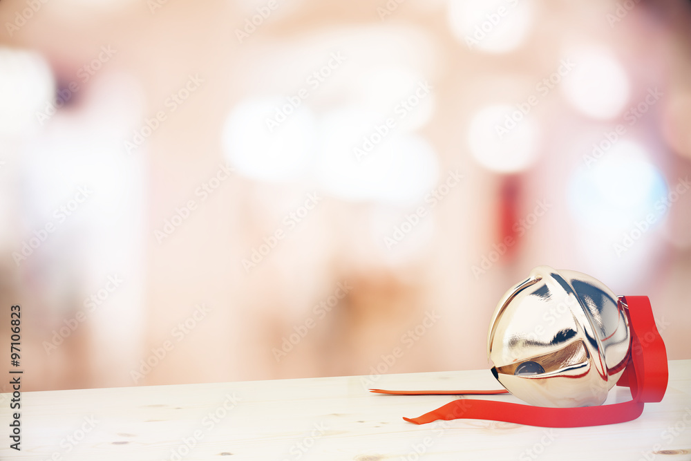 Christmas jingle bell with red ribbon on the table