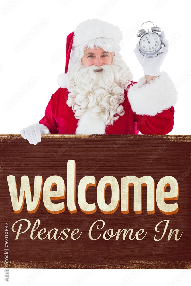 Composite image of santa claus holding alarm clock and sign