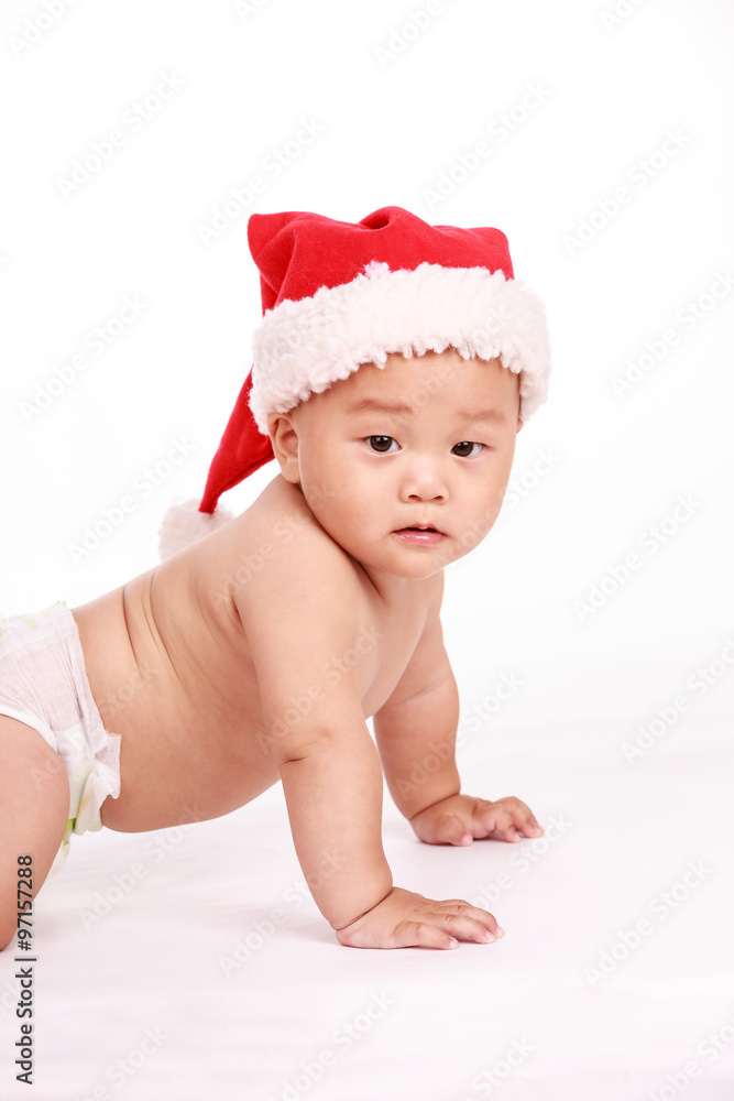 cute Oriental baby boy wearing christmas cap