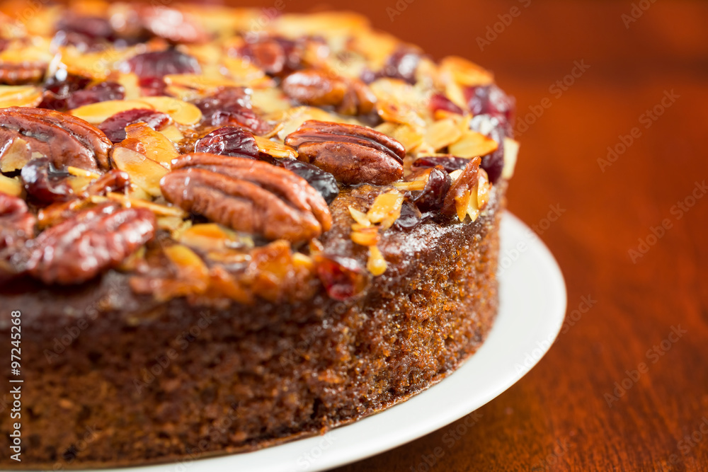 Pecan cake made with sliced almonds and dried cranberries 