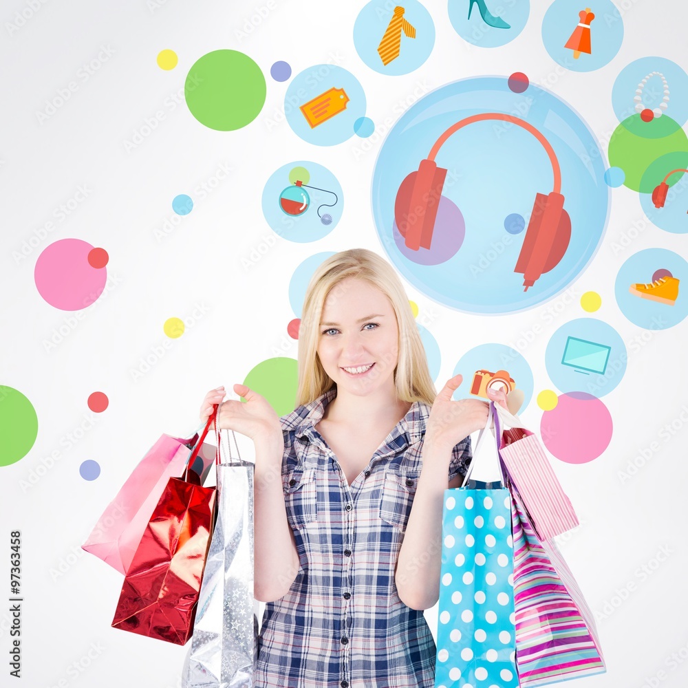 Composite image of pretty young blonde holding shopping bags