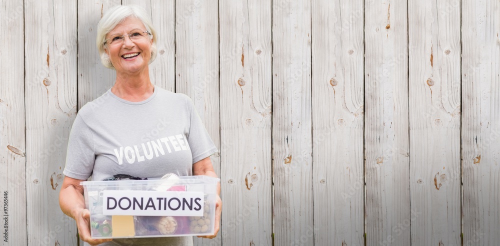 Composite image of happy grandmother holding donation box