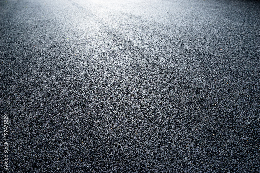 asphalt road under light