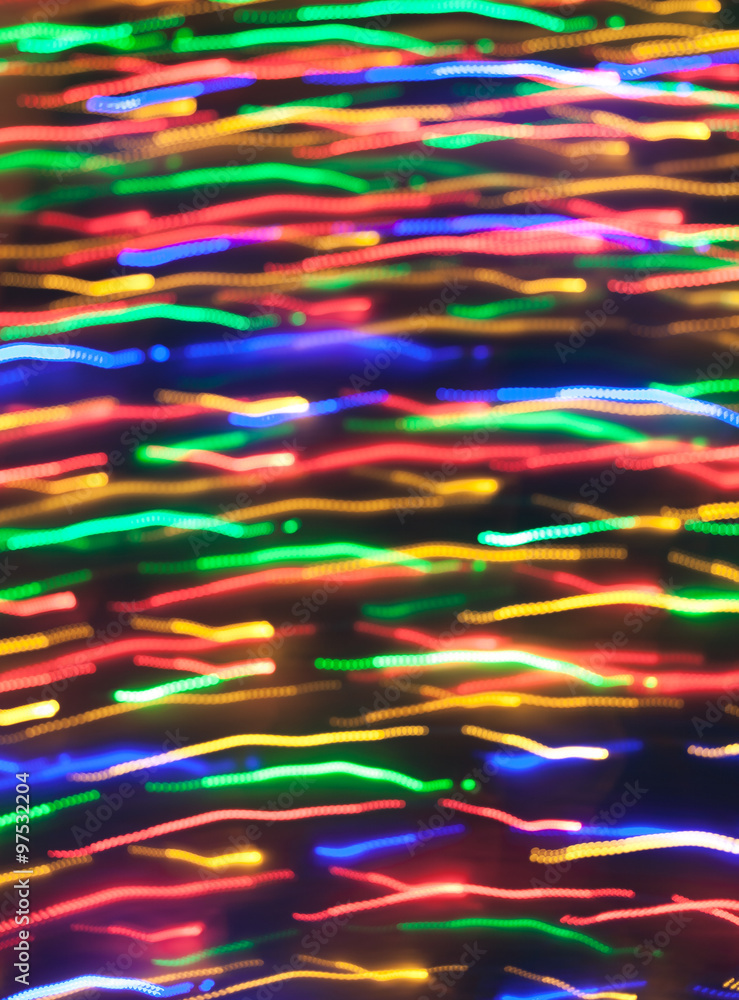 Defocused christmas lights with motion blur. New Year bokeh