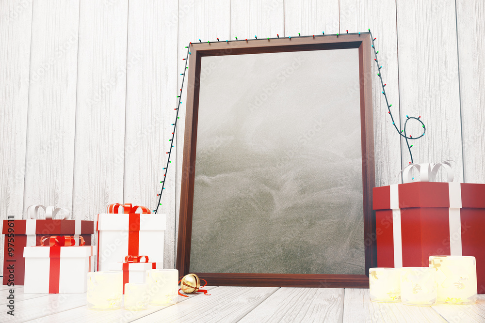 Blank picture frame  with gift boxes and glowing candlesticks on