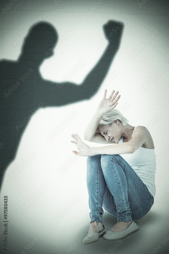 Composite image of scared woman protecting herself 