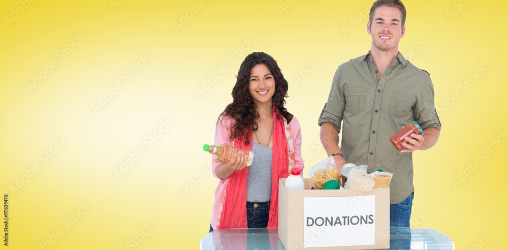 Smiling volunteers taking out food from donations