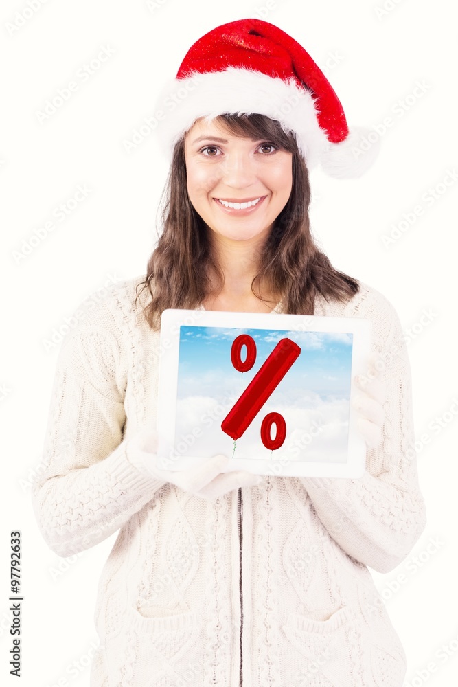 Composite image of festive brunette holding a tablet pc