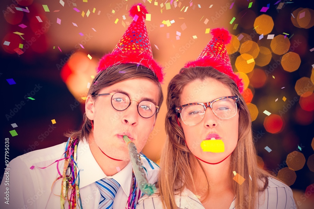 Composite image of geeky hipster wearing a party hat 