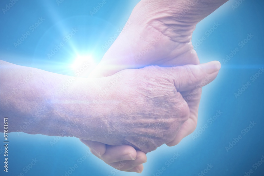 Composite image of elderly couple holding hands