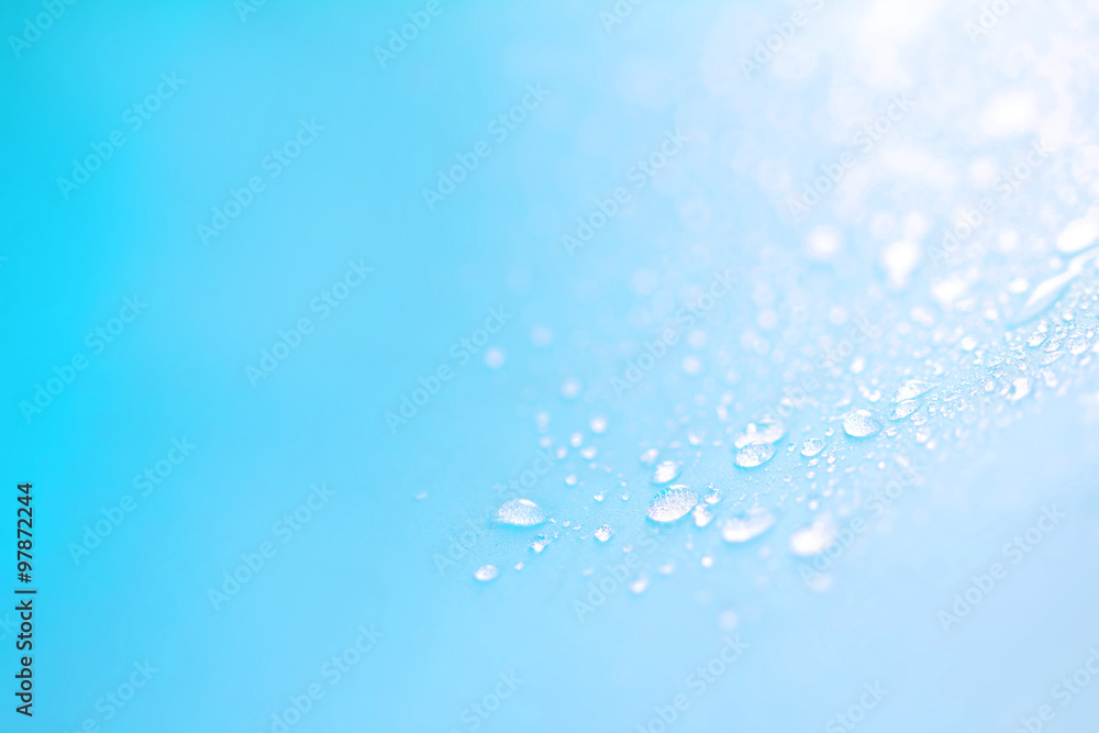 Close up rain water drops on blue sponge surface as abstract bac