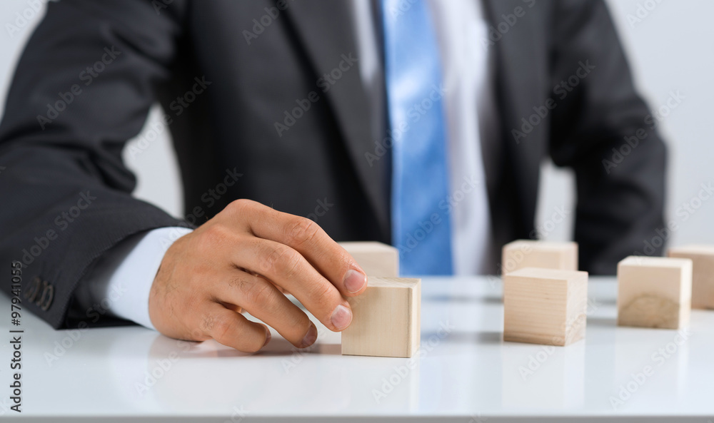 Businessman making tower