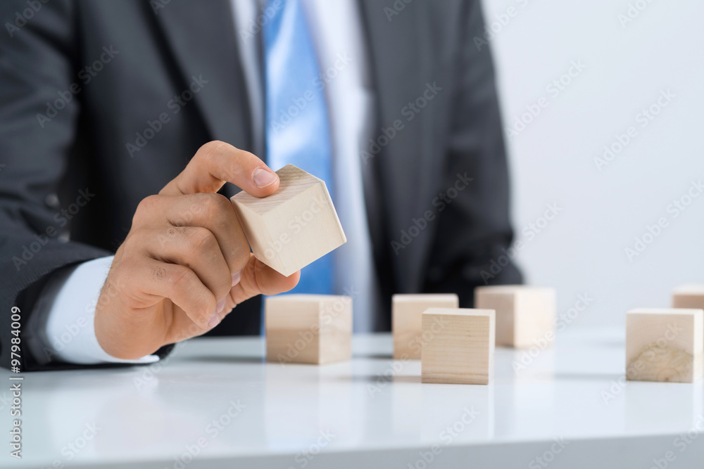 Businessman making tower