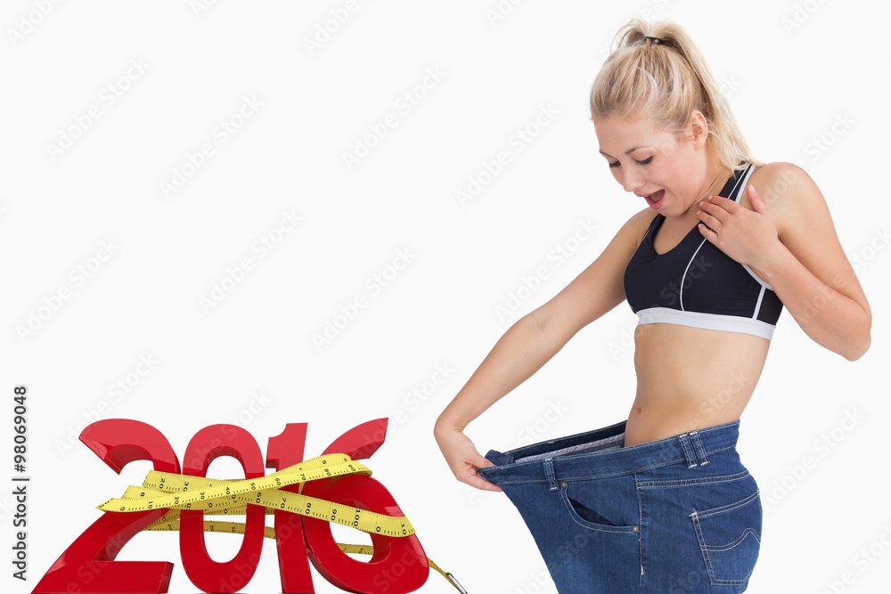 Young thin woman wearing old pants after losing weight