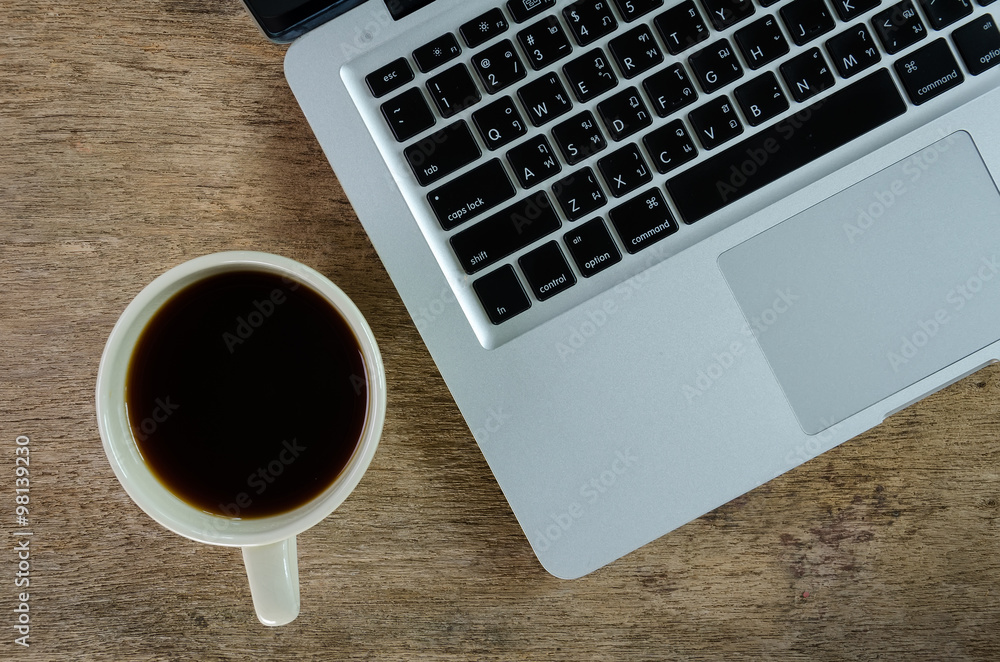  laptop and coffee cup on old wooden table