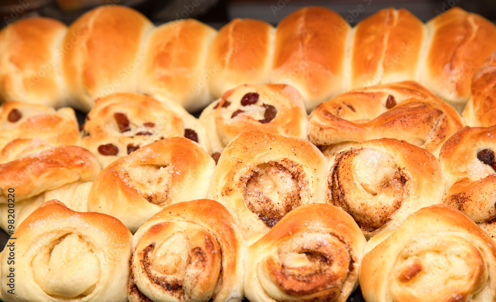 The fresh buns and pies on a baking sheet which are just pulled