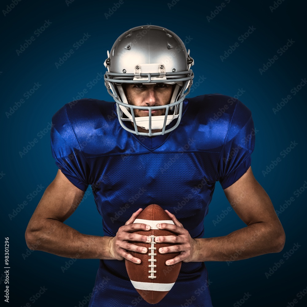 American football player holding ball