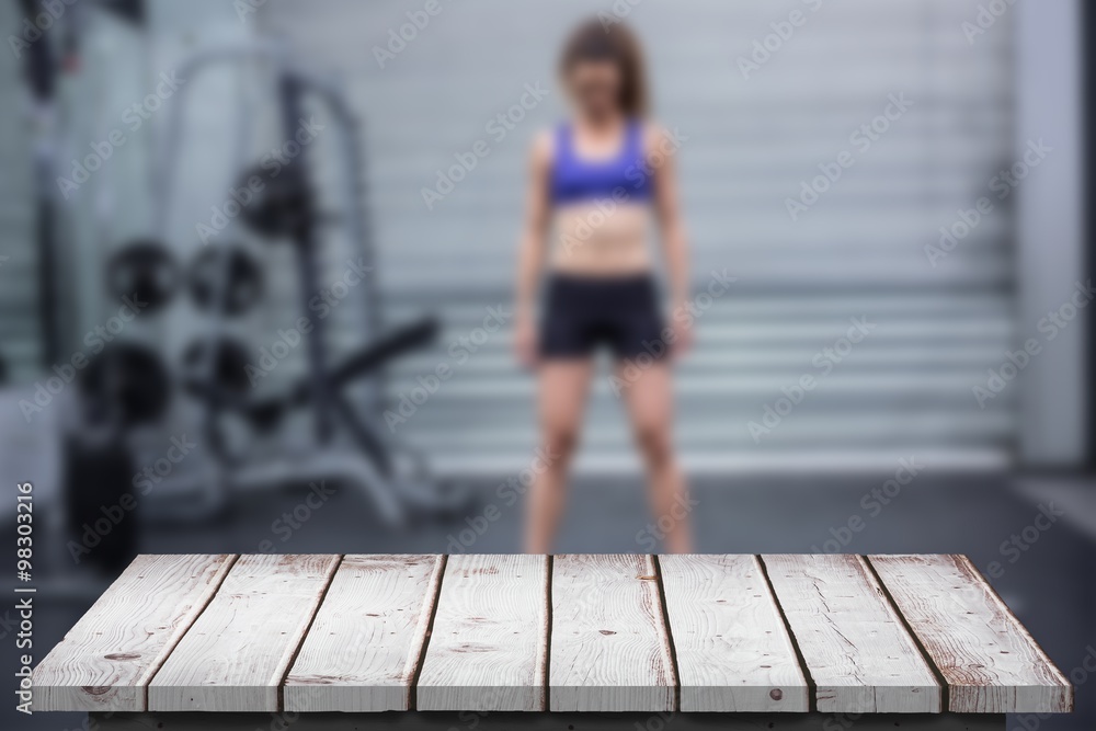 Composite image of muscular woman with barbell