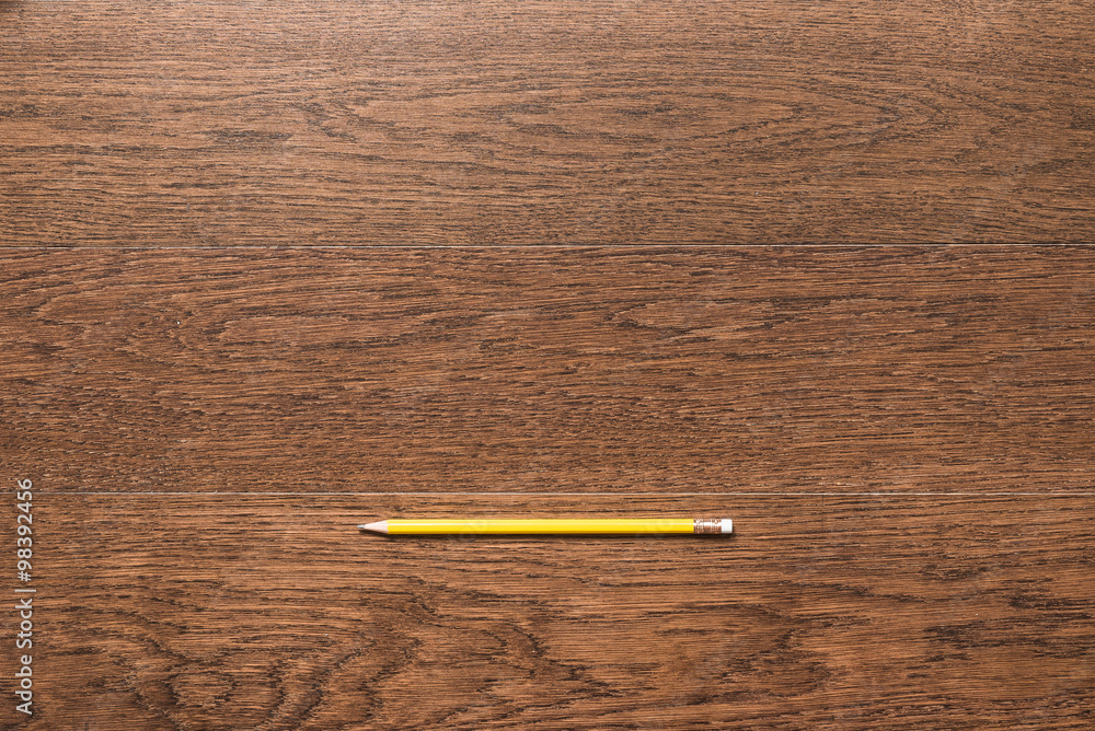 yellow pencils on wooden background