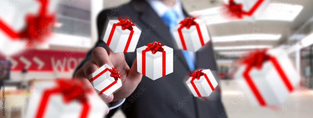 Man celebrating christmas holding gift in his hand