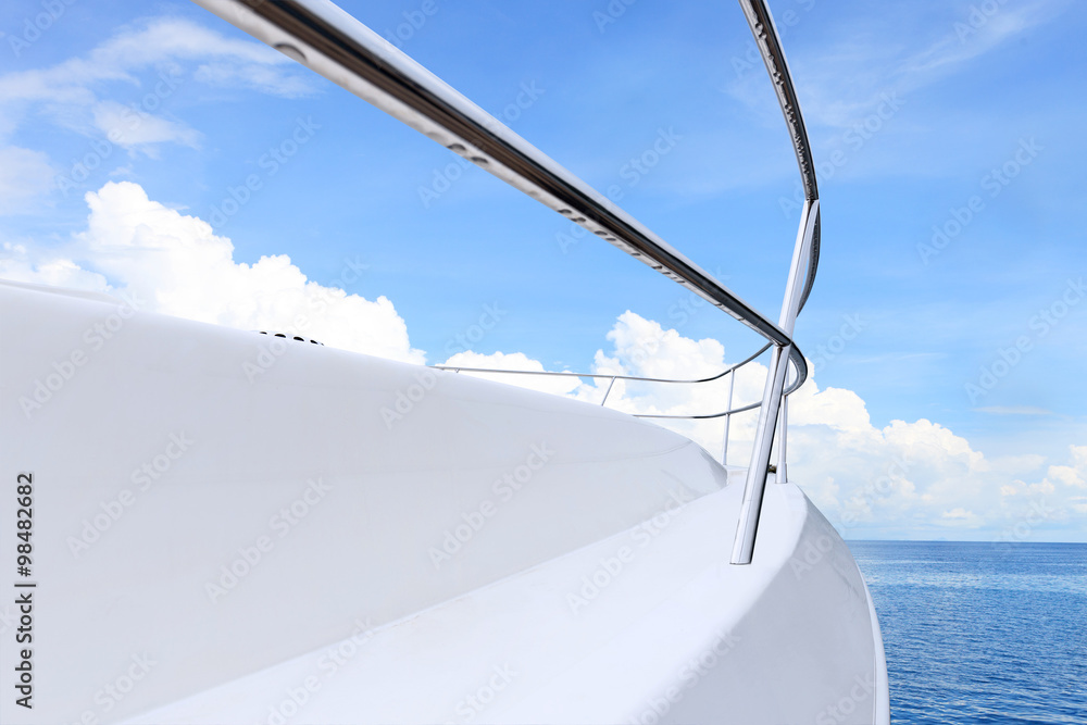 blue sky above white yacht on water