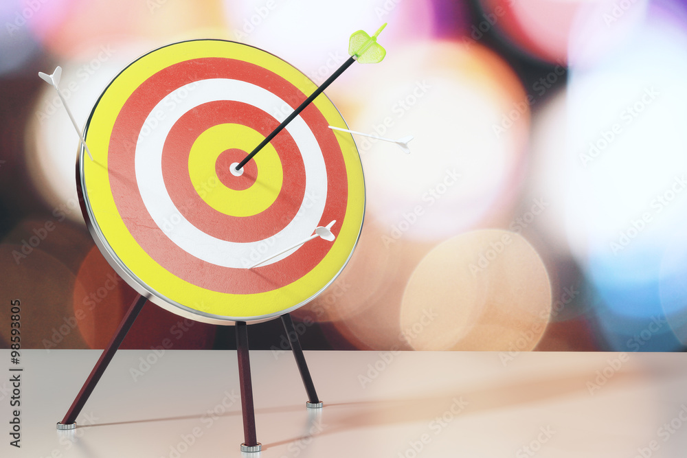 Bulls-eye with arrows on white table