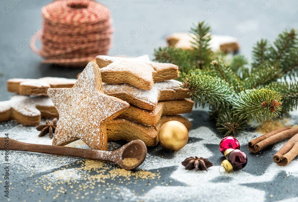 Cooked Christmas holiday traditional gingerbread cookies with sugar powder, anise and cinnamon stick