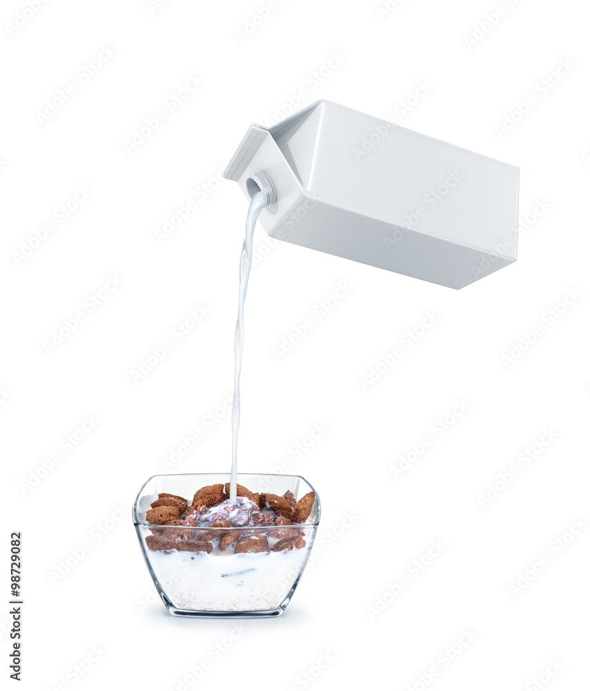 pouring milk into cornflakes bowl isolated on white