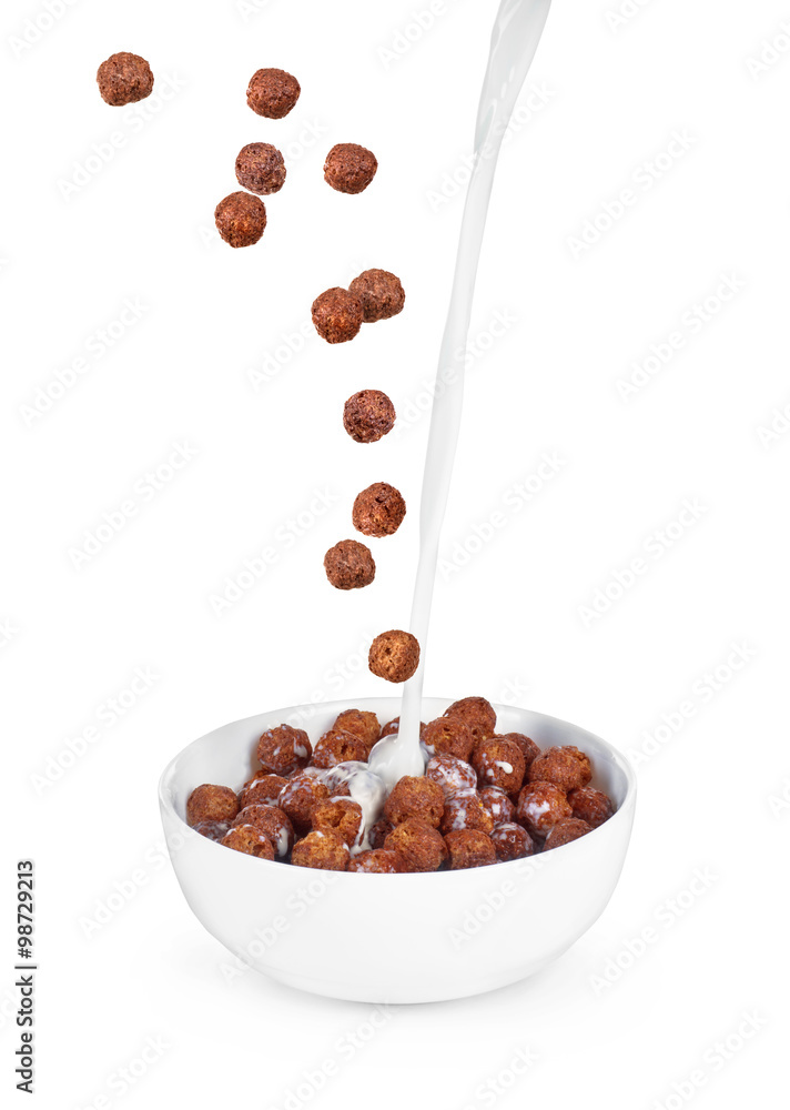 pouring milk into cornflakes bowl isolated on white