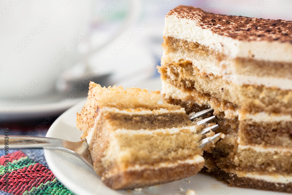 Tiramisu cake with cup of coffee