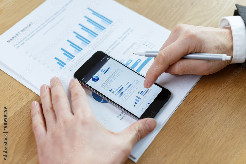 businessman checking financial reports on table