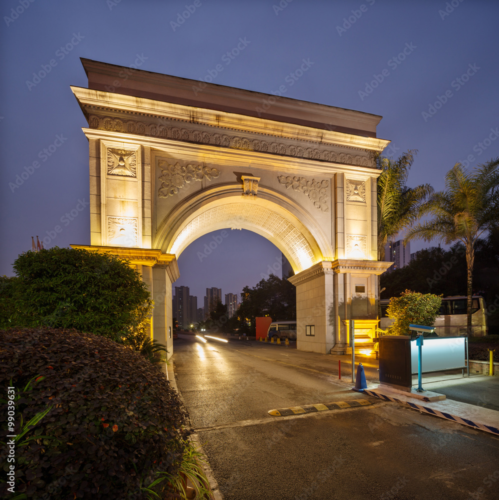 empty road through luxury architecure at night