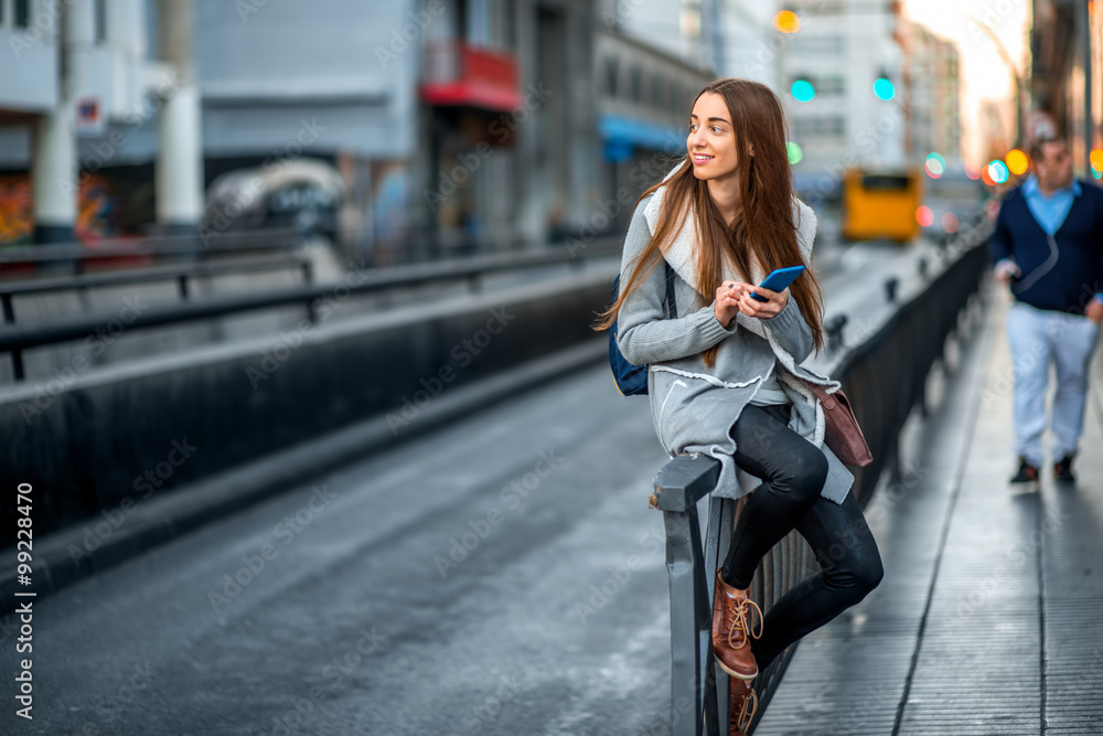 Woman with phone in the city