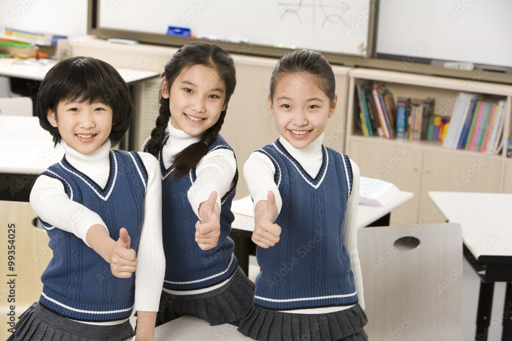 Students giving thumbs-up in the classroom