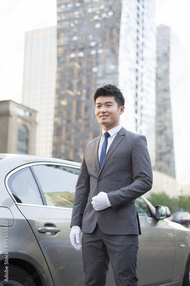 Chauffeur standing next to the car