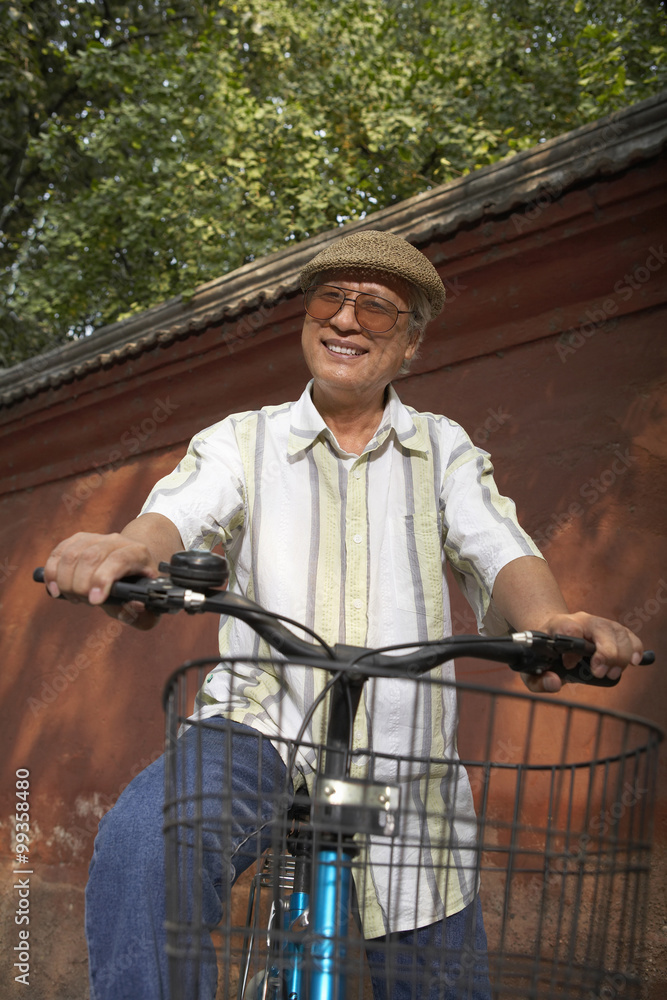 Portrait Of Elderly Man On A Bicycle