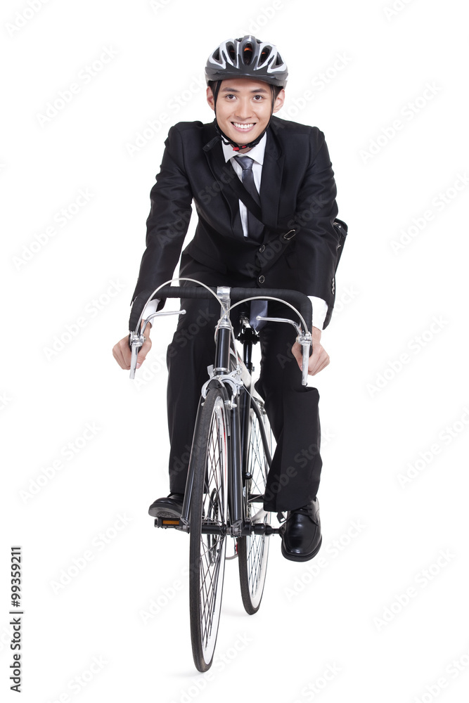 Portrait of young businessman riding a bike