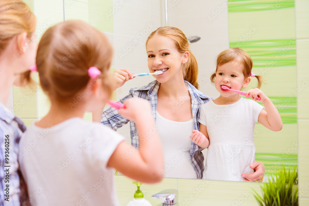 happy family mother and daughter child brushing her teeth toothb