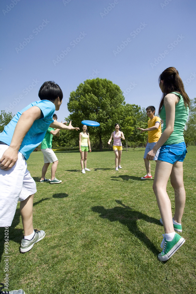 A group of friends playing with a Frisbee