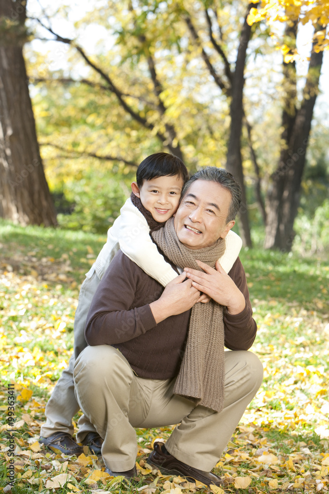 Boy embracing his grandfather