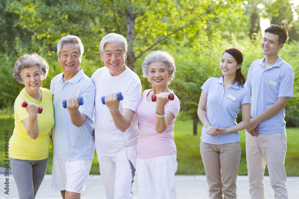 Seniors  exercising with dumbbell in nursing home